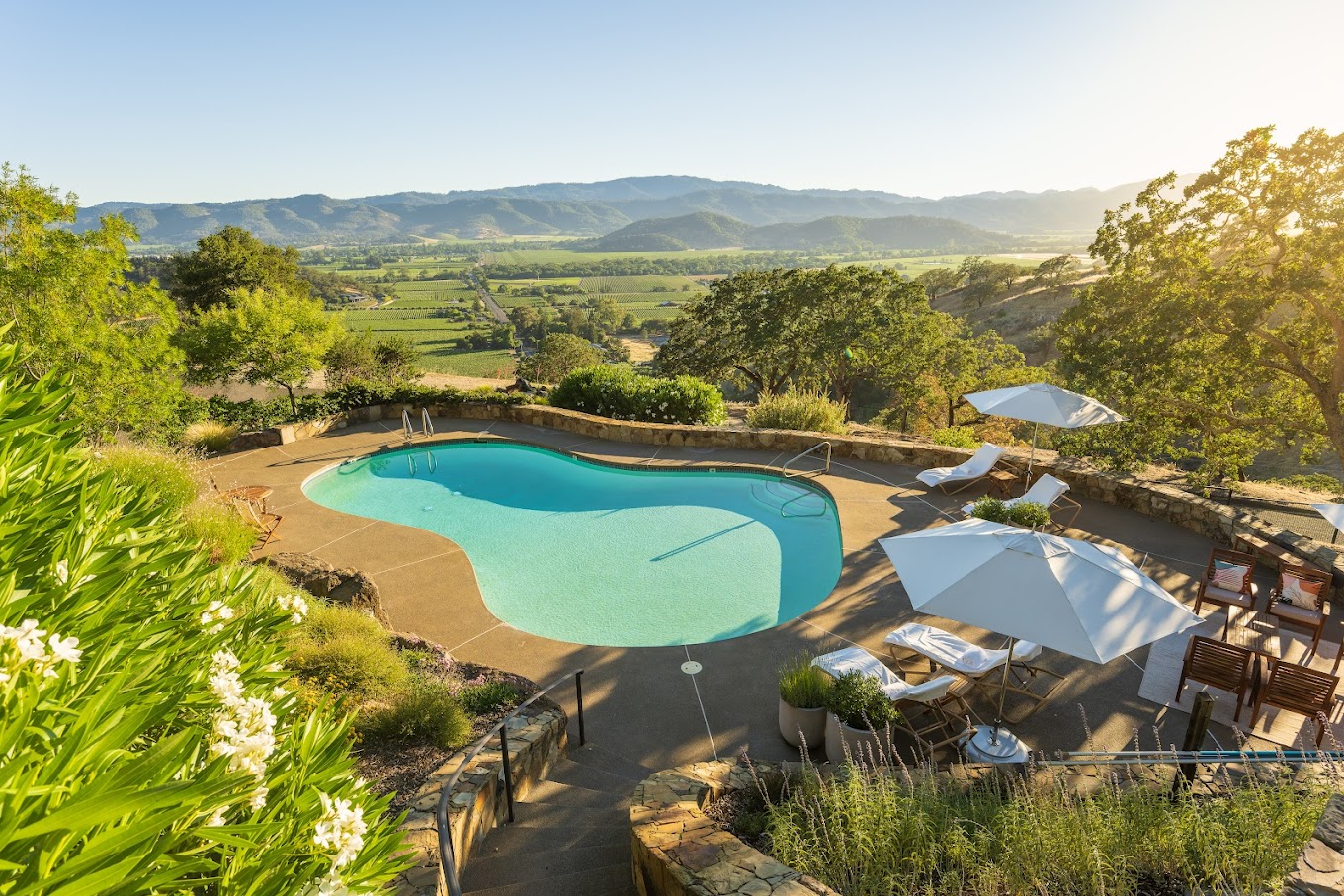 Outdoor panorama of a pool and vinyard view at Poetry Inn Napa Valley