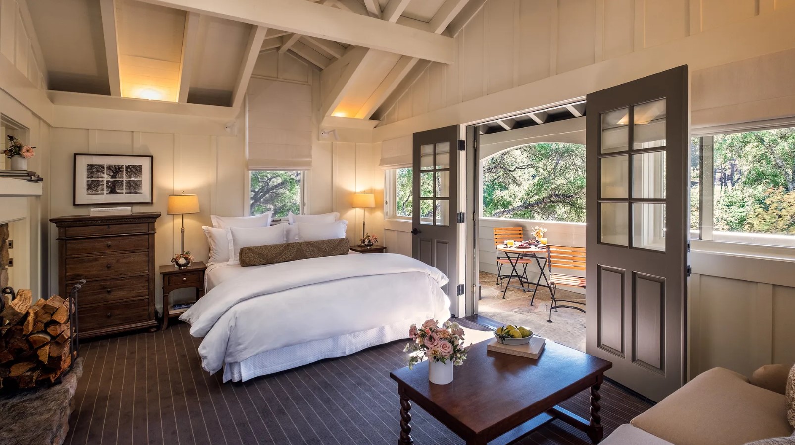 Image of Meadowood Cottage room with bed, sitting area and doors leading to private porch