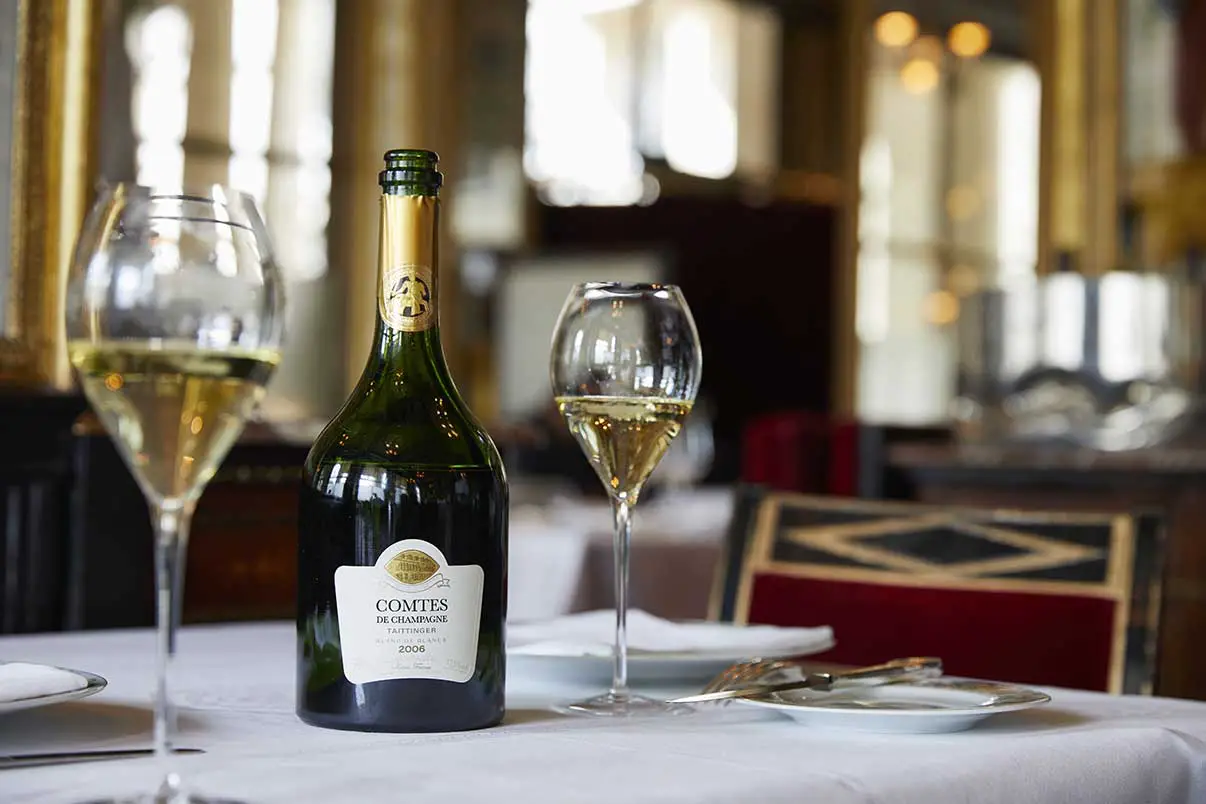 Champagne Taittinger served on a table with glasses