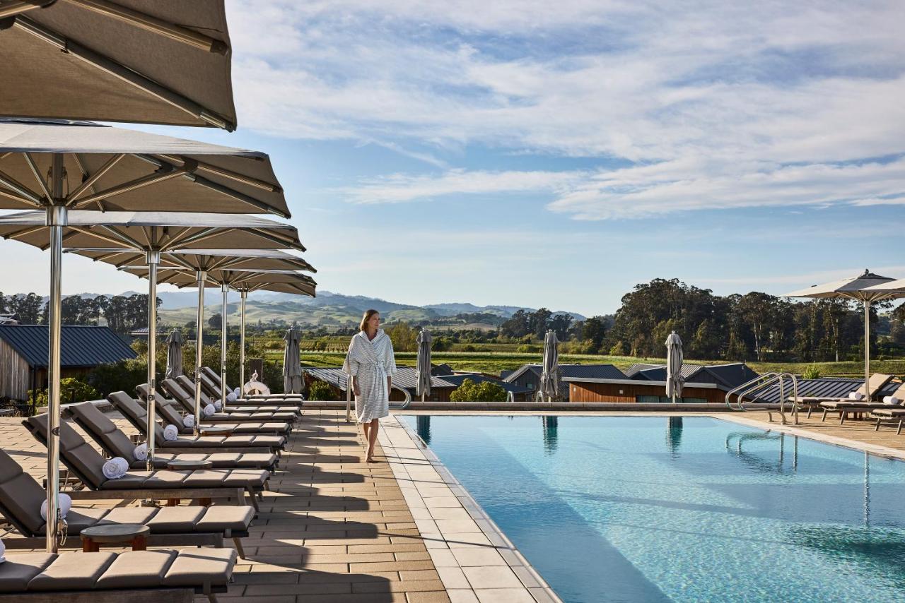 Woman walking by the pool in Stanly Ranch, Auberge Resorts Collection