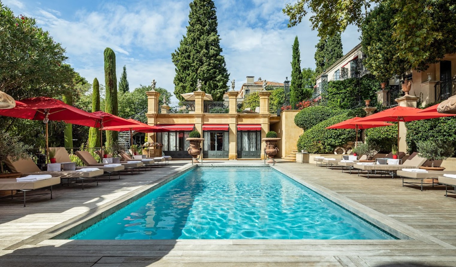 Outdoor pool and a Villa Gallici - Relais & Châteaux hotel view