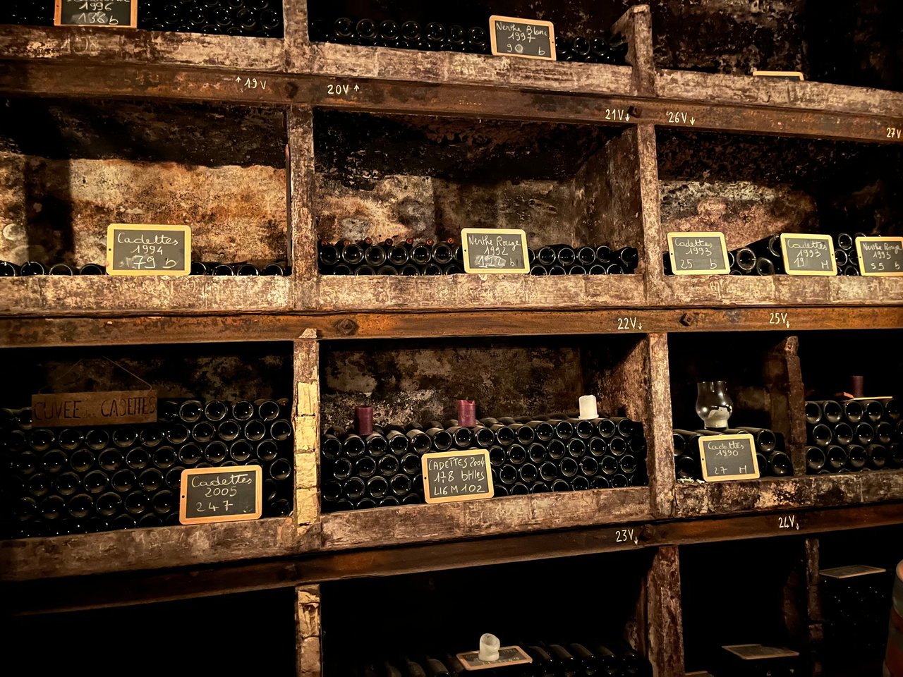 Château La Nerthe archive and vintage wine cellar with bottles laid on the shelves